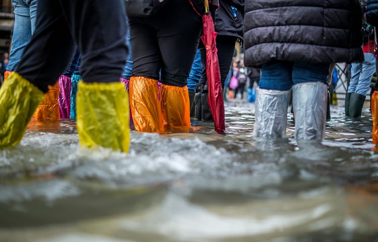 Tourists try to stay dry in a flooded St Mark’s Sq, venice